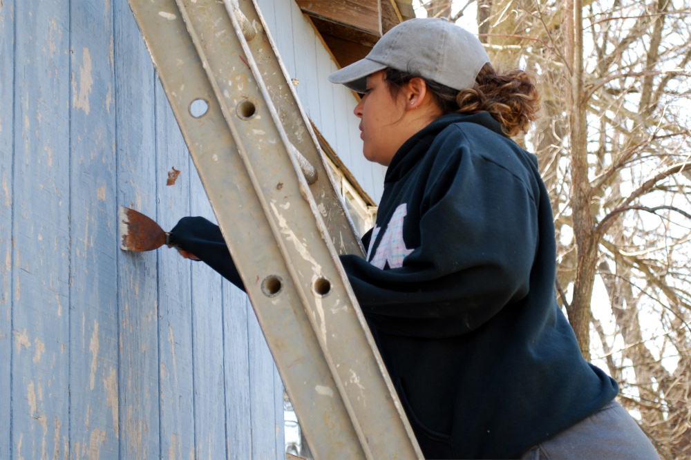 A student painting on Service Day